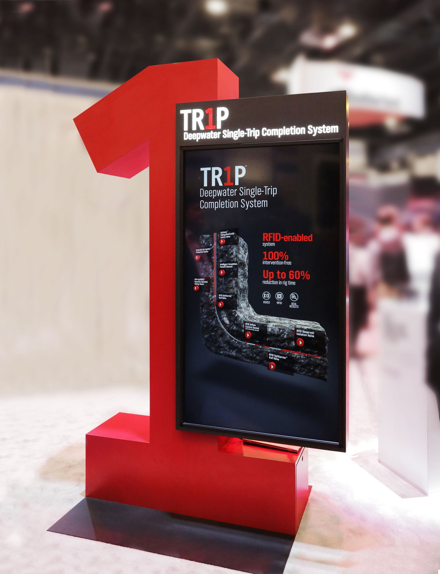 The TR1P kiosk: a large red numeral 1 holding a portrait touchscreen on a trade-show floor